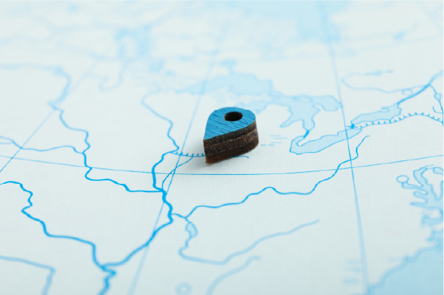 Close-up of a blue location pin on a map representing property location or site marking.