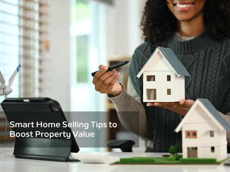 Woman holding miniature house model while discussing smart home selling tips to boost property value